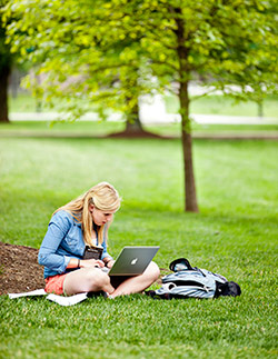 Student studying on grass