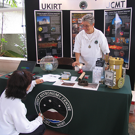 Inge Heyer at a booth conducting astronomy community outreach at Onizuka Day in Hilo, Hawaii in 2009.