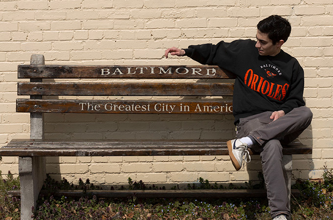 Andrew sitting on a Baltimore bench