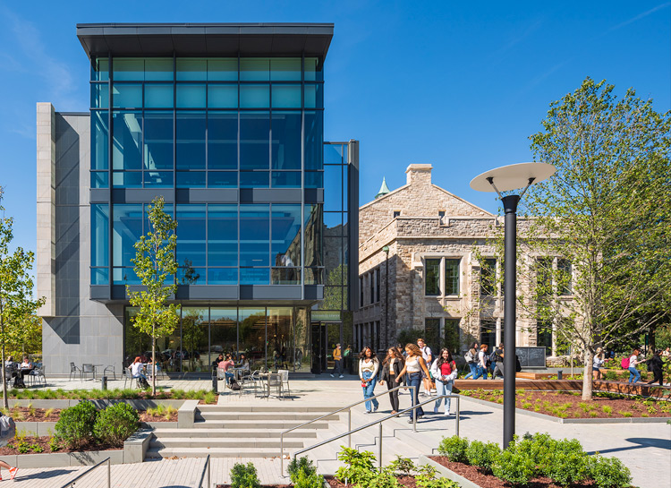 Students walking on campus in front of the new Fernandez building