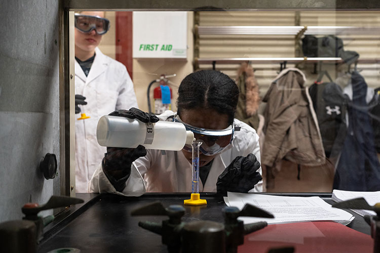 Student using chemicals in a fume hood