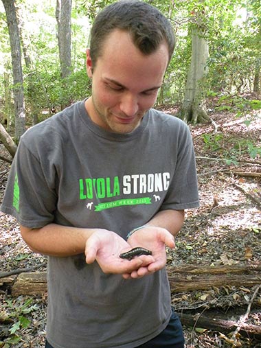 Student holding a salamander