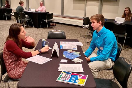 Rachael Degnan, Howard County Public School System , speaking with a  student at the 2019 Career Night
