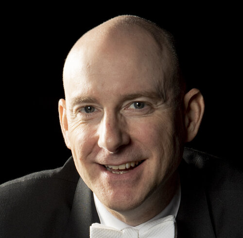 Headshot of Clay Price with a conducting baton