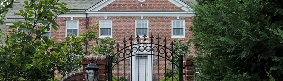 Alumni House entrance gate with building in the background