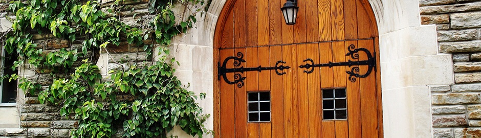 The Chapel's wooden doors with ivy growing alongside the building