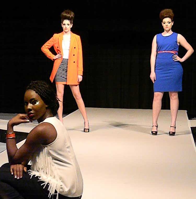 2 female models mirror poses in bright colored dresses while one model in black and white poses front and center
