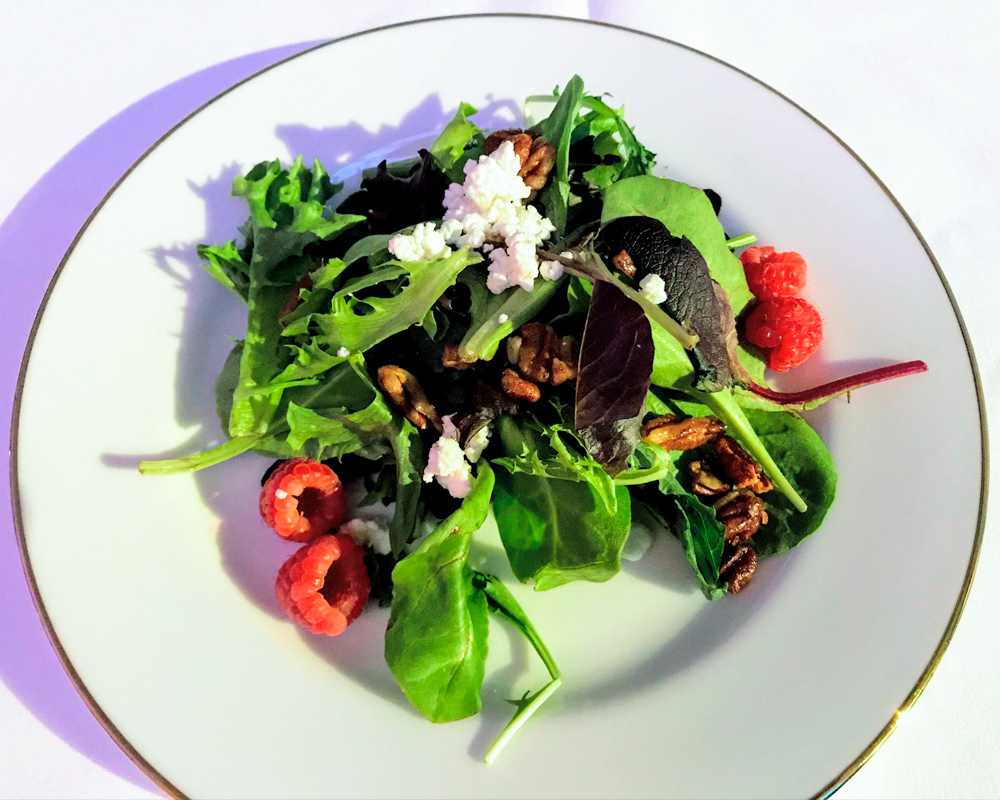 Mixed greens salad with goat cheese, pecans, and raspberries