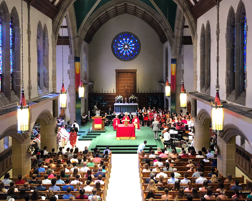 The interior of Loyola's Alumni Memorial Chapel, showing many pews