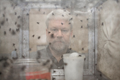 David Rivers looking at insects through a container