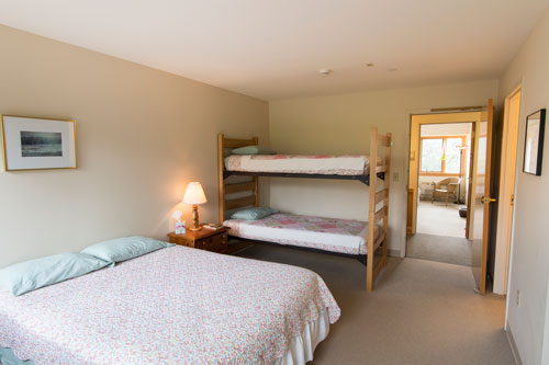 View of Queen Anne room with full bed and bunk bed