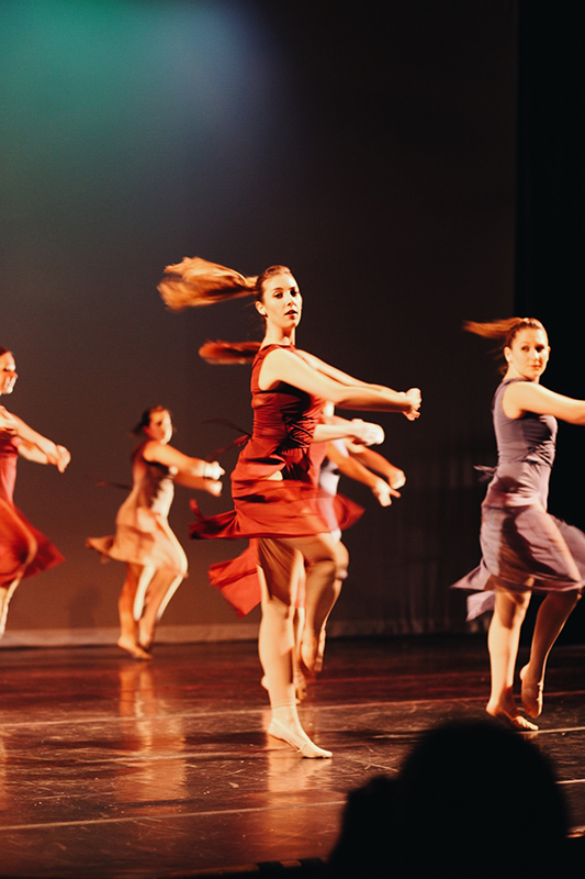Members of Loyola's Dance Company dancing on stage