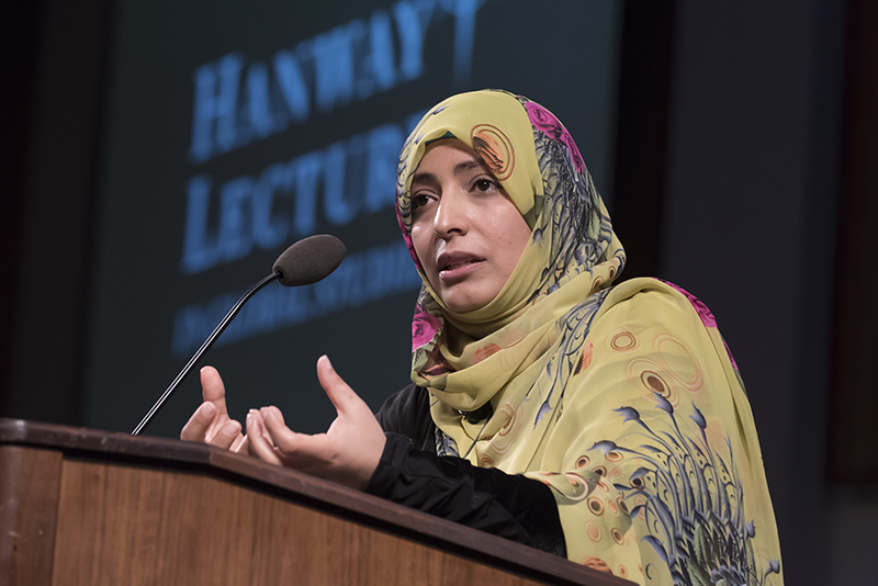 A presenter speaking at a podium during Loyola's annual Hanway lecture