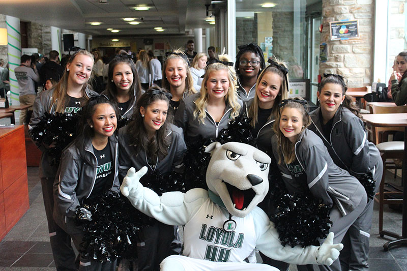 Cheerleaders posing with Loyola's greyhound mascot, Iggy
