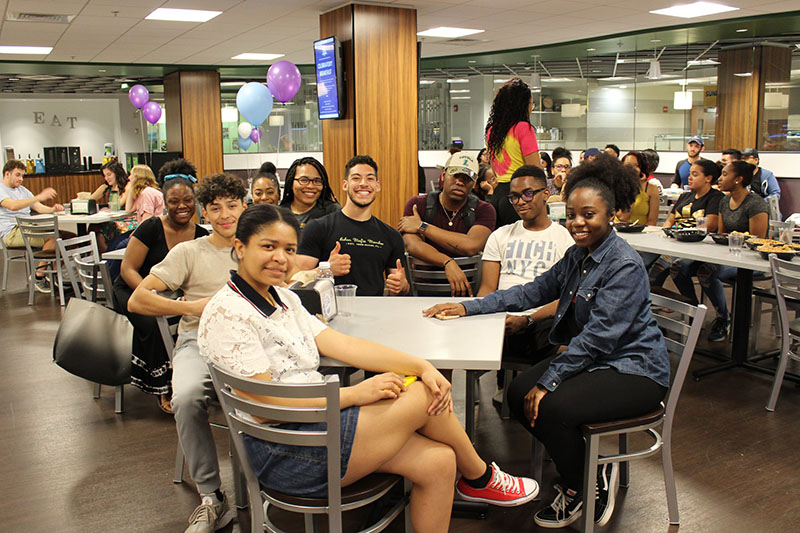 Students pose for a photo while sitting in one of Loyola's dining areas
