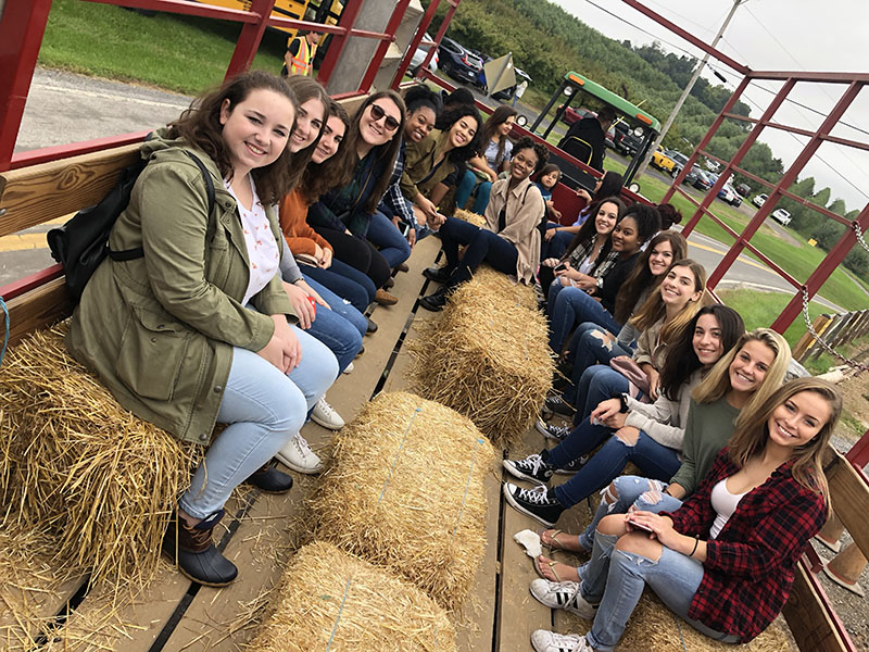 Students smile for the camera while on a hayride