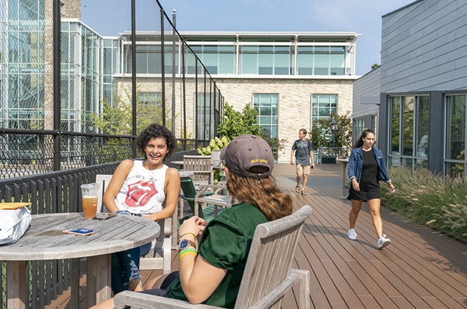 Students seated at a table near the Modular Buildings on campus