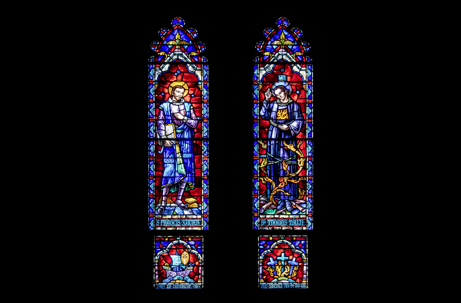 Two colorful stained glass panels of St. Francis Xavier and Blessed Thomas Tsuji