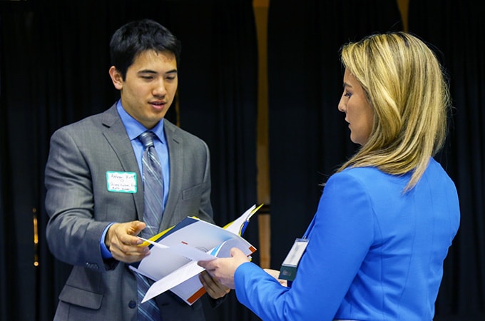 Student at the career fair talking to an employer