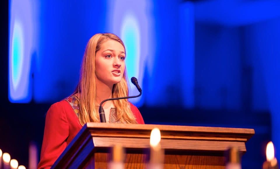 Female student speaking at pulpit
