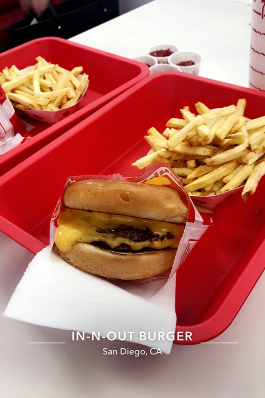 Cheeseburger and basket of fries sitting on a tray at In-N-Out Burger