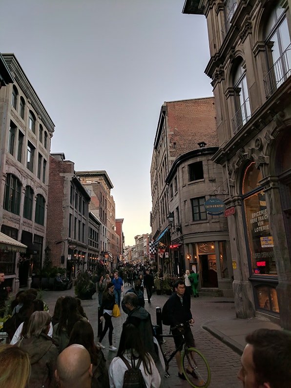 People walking through a crowded street in downtown Montreal