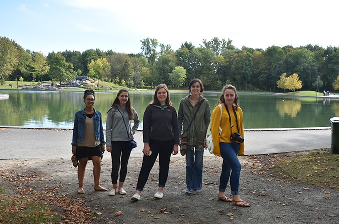 Group of Loyola students posing in front of a pond at Mont Royal Park