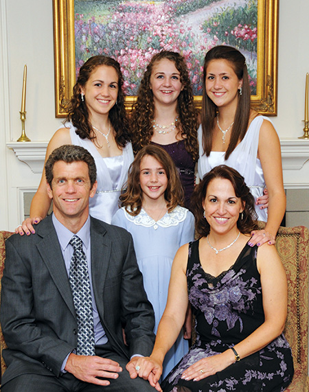 The McComas family posing for a portrait in their home