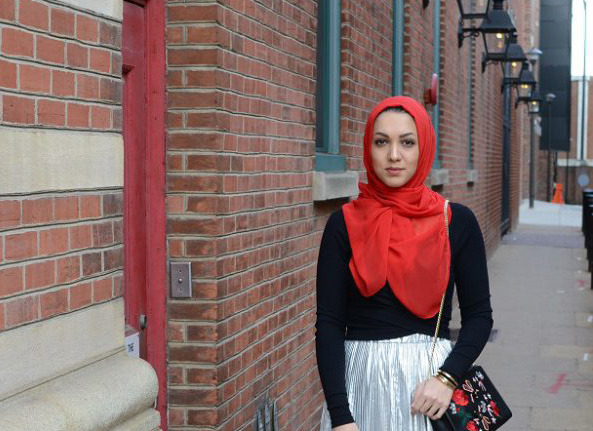 Photo of Hanyeh Khoshnevisan modeling a red hijab and matching purse.