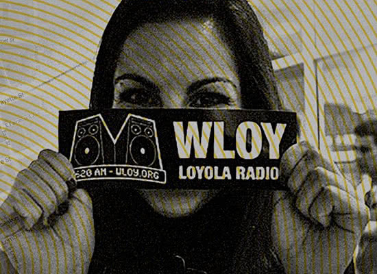A female student holding a WLOY Loyola Radio bumper sticker