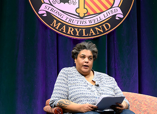 Roxane Gay seated on Loyola's stage.