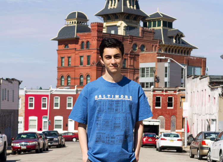Andrew standing in front of brick buildings in Baltimore