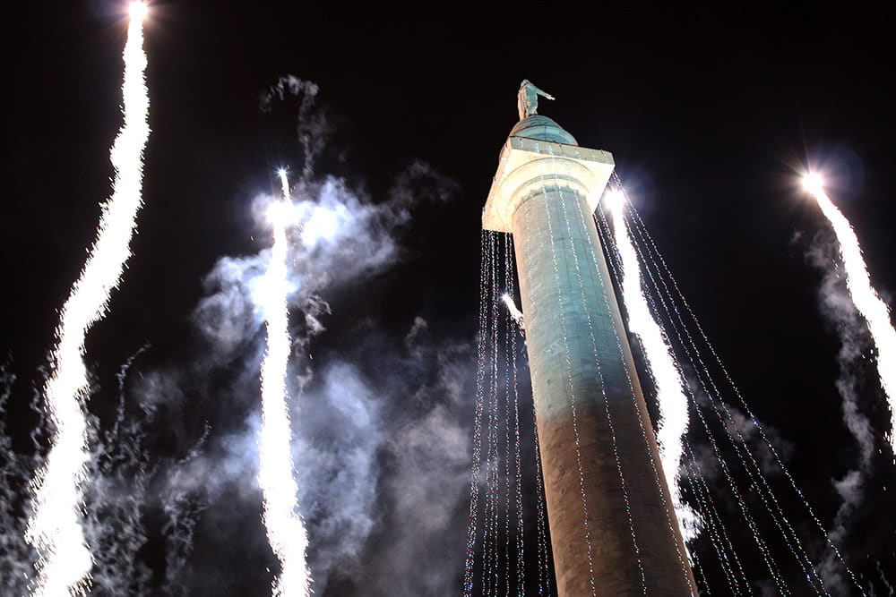 White fireworks fly up around the Washington Monument in Baltimore