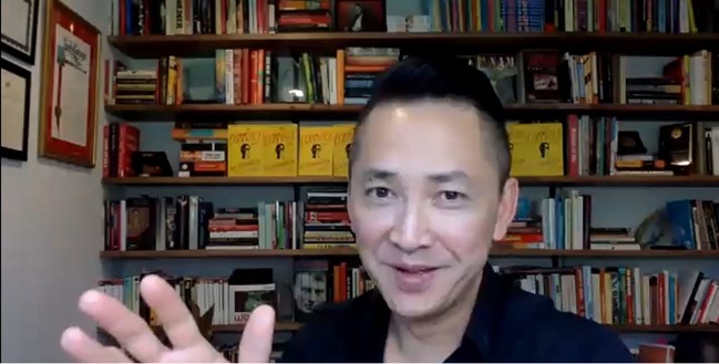 Photo of award winning author Viet Thanh Nguyen, Ph.D. waiving.