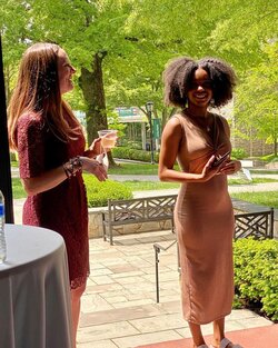 Knekiya Harper gave a speech on the porch of the Humanities during the CPC graduation celebration. CPC Program Director Dr. Emalee Quickel cheers her on.
