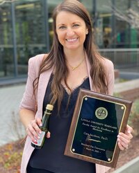 Cara Jacobson, Psy.D., with her Faculty Award for Excellence in Mentoring