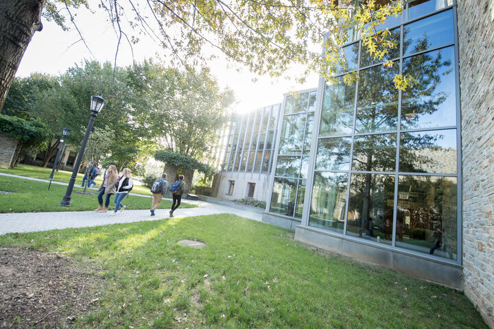 Students walking in front of the glass façade of the Donnelly Science Center