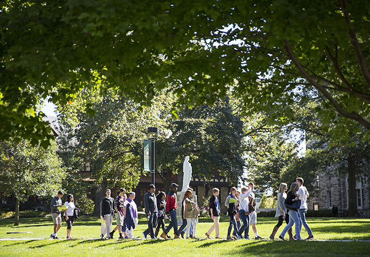 A tour of parents and prospective students walk across the Academic Quad on Loyola's Evergreen campus