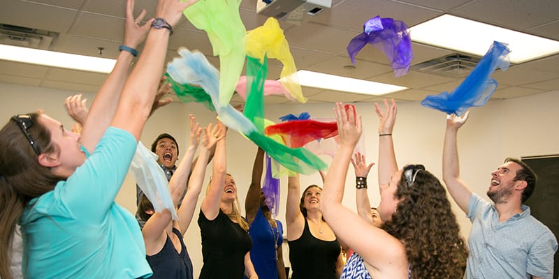 Kodaly students tossing scarves in the air during classroom instruction