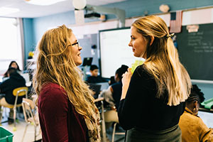 Teacher and intern talking to each other in the classroom