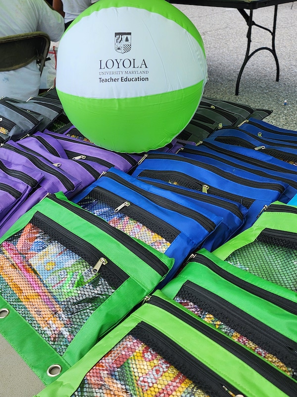 school supplies on a table wiht a Loyola University beach ball in the background