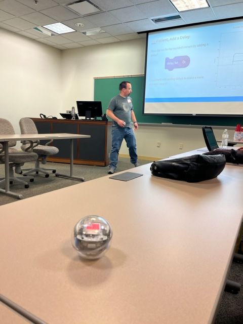 Sphero Bolt sitting on a table with Ben Hurley presenting in the background