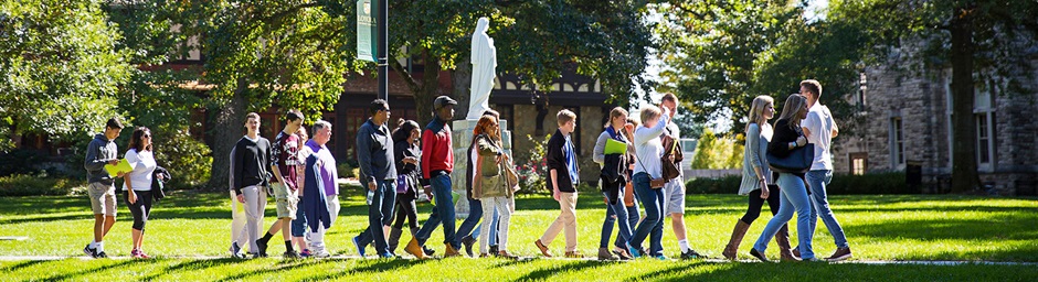 Visitors walking on campus during a tour on a sunny day