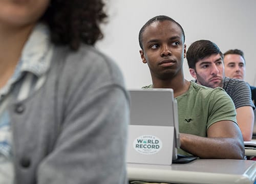 A student looks up from up tablet during class