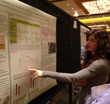 Student giving a poster presentation