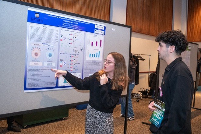 student presents poster