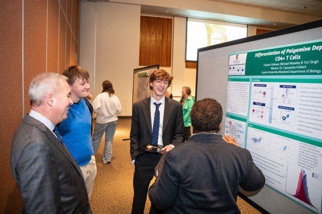student presents poster