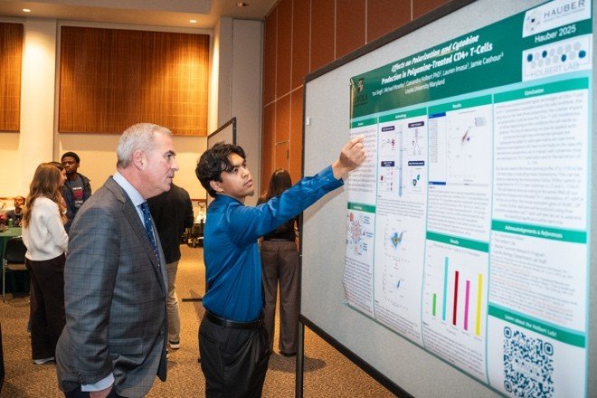 student presents poster