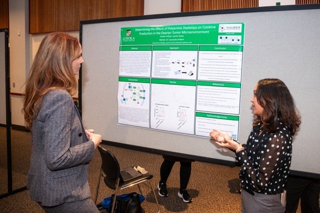 student presents poster