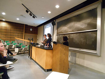 Dr. Nandini and students behind a podium in a classroom